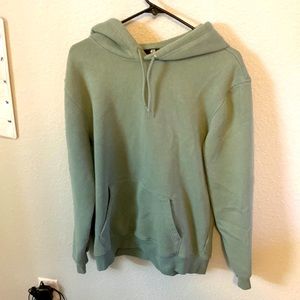 A light greenish medium H and M sweatshirt.